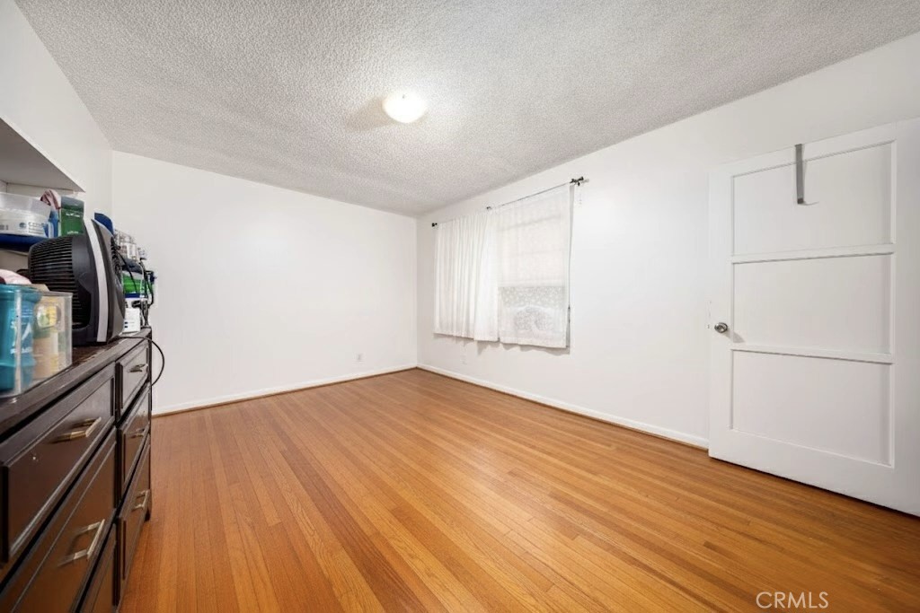 12203 Klingerman Street El Monte, CA 91732 - Photo 7 of 21 a view of empty room with wooden floor and fan