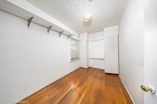 a view of a room with wooden floor and brick walls
