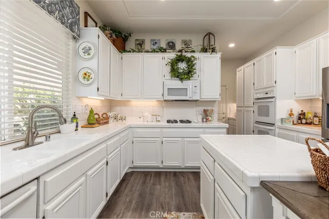 a kitchen with a sink stove and cabinets