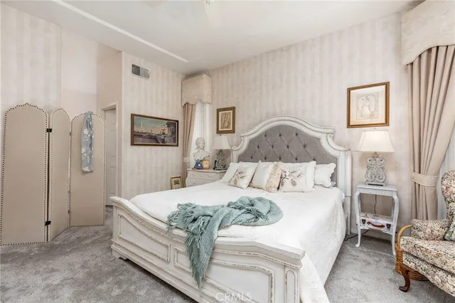 a bedroom with a bed and a mirror