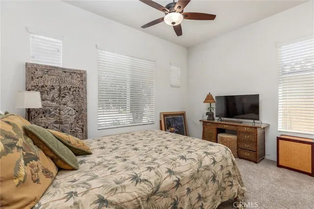 a bedroom with a bed and a television