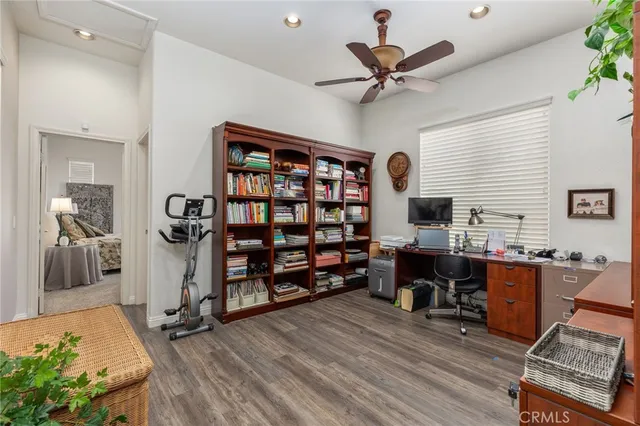 a view of a livingroom with workspace and a window