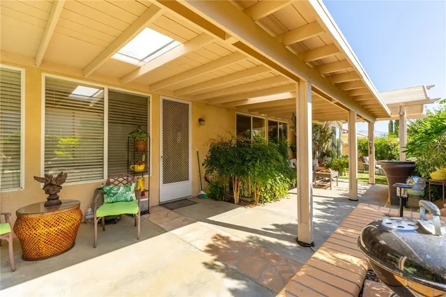 a balcony with furniture and a potted plant