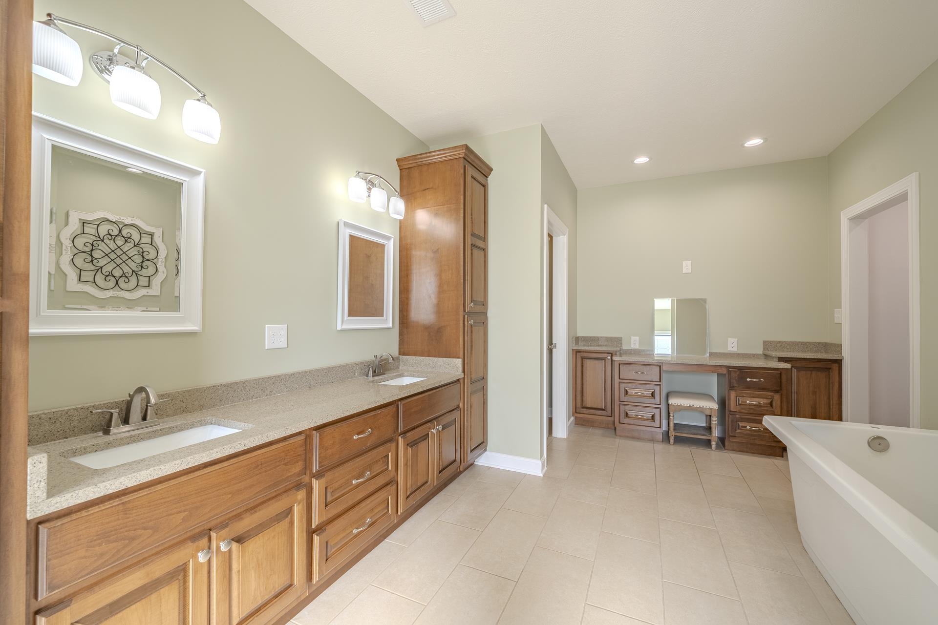 170 Kirk Cove Adamsville, TN 38310 - Photo 18 of 39 Full bathroom featuring double vanity, a freestanding tub, light tile patterned flooring, and recessed lighting