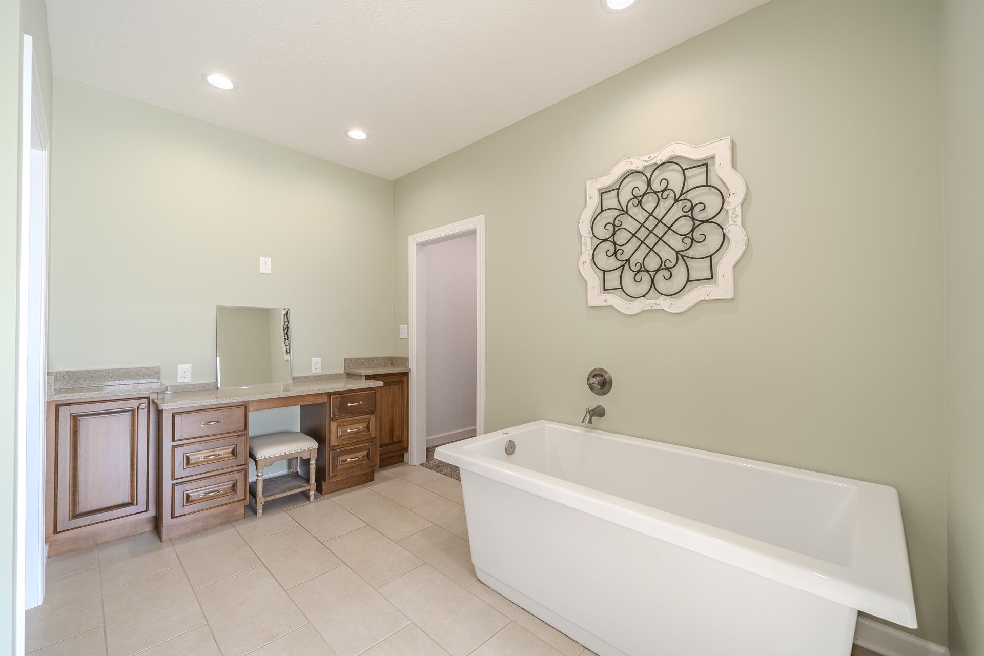 170 Kirk Cove Adamsville, TN 38310 - Photo 19 of 39 Full bathroom with vanity, a soaking tub, recessed lighting, and light tile patterned floors