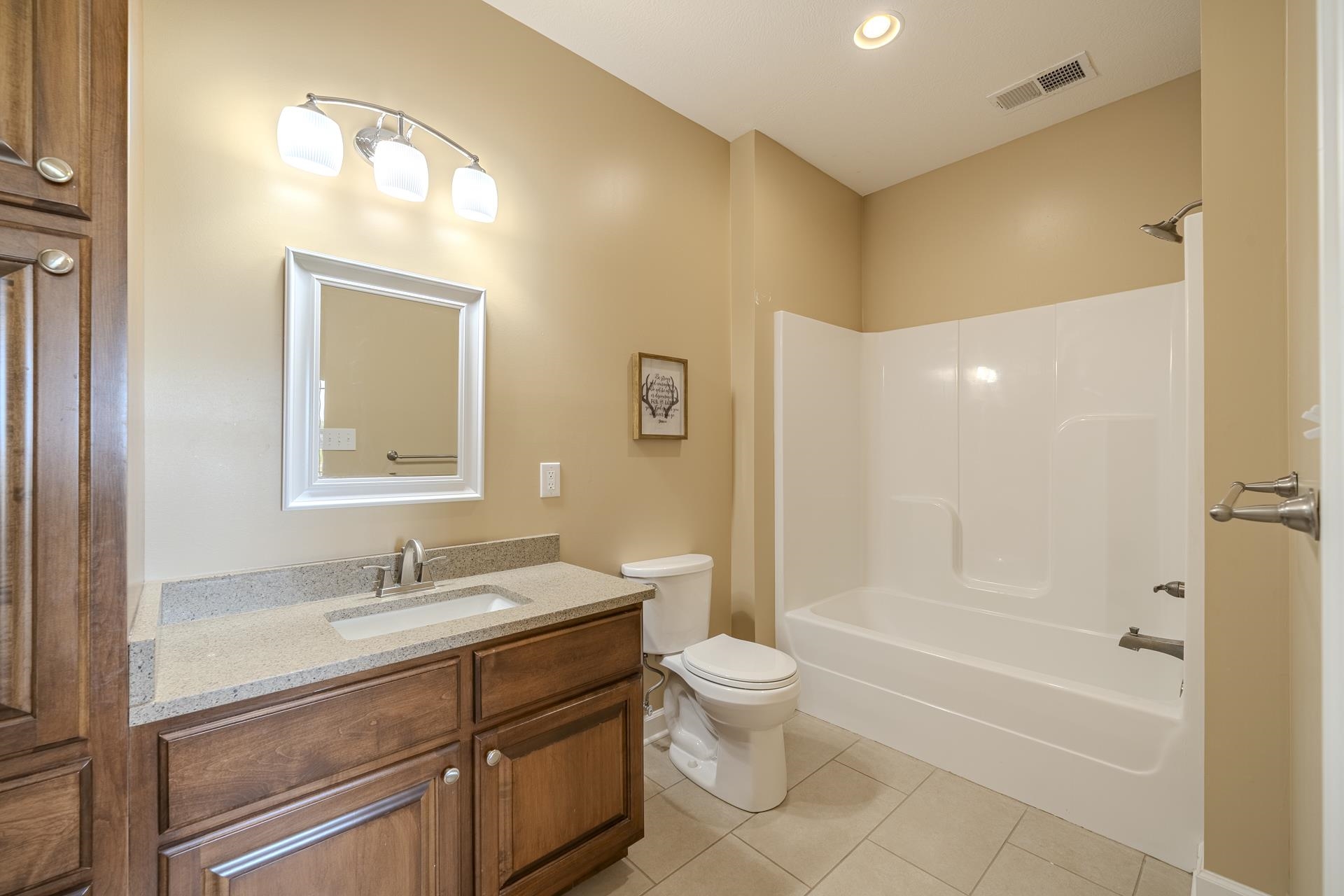 170 Kirk Cove Adamsville, TN 38310 - Photo 25 of 39 Full bathroom with vanity, light tile patterned flooring, bathtub / shower combination, and recessed lighting