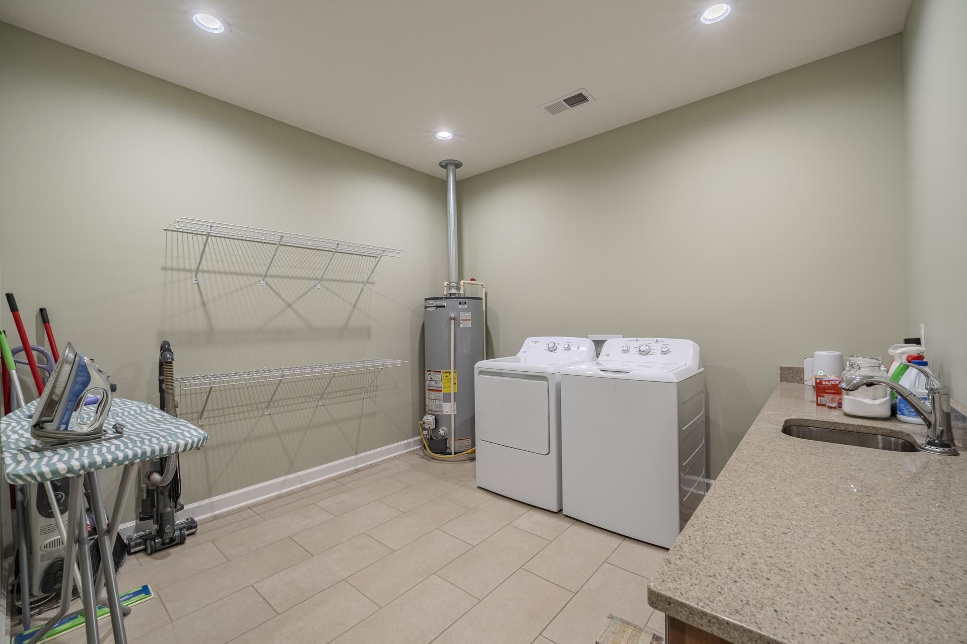 170 Kirk Cove Adamsville, TN 38310 - Photo 27 of 39 Laundry area with gas water heater, washing machine and dryer, recessed lighting, and light tile patterned floors