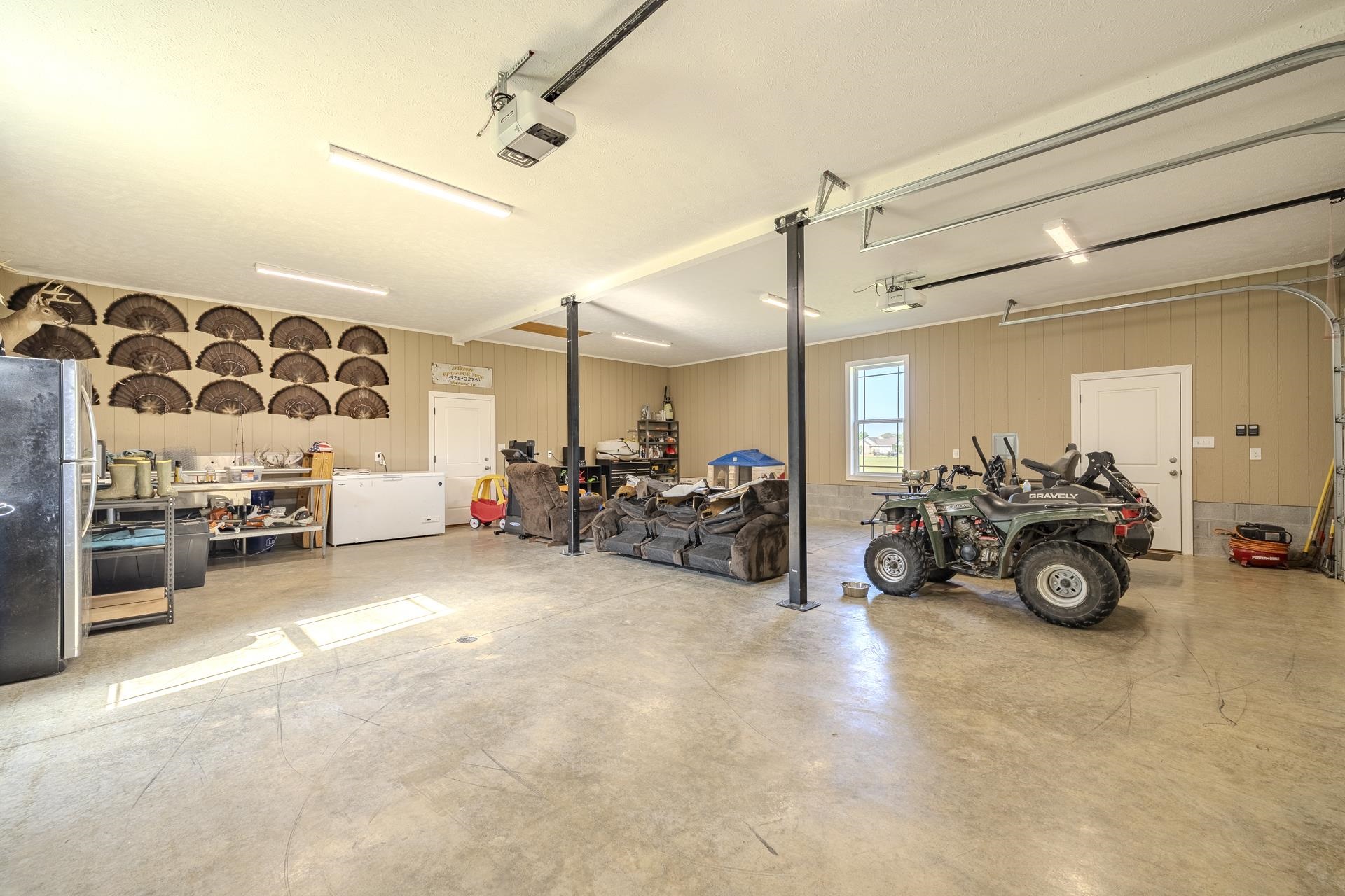 170 Kirk Cove Adamsville, TN 38310 - Photo 32 of 39 Garage featuring freestanding refrigerator and a garage door opener