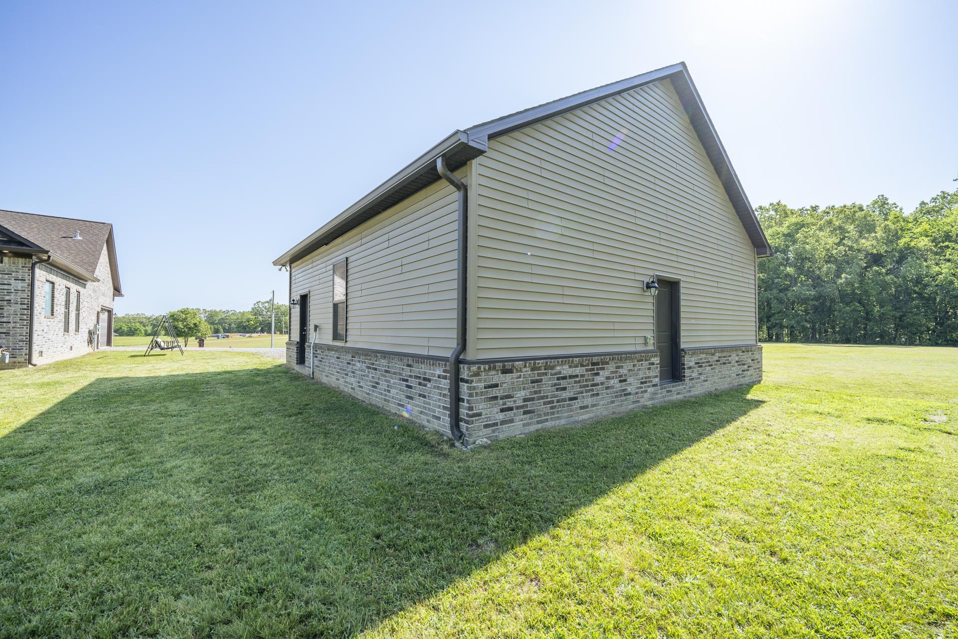 170 Kirk Cove Adamsville, TN 38310 - Photo 33 of 39 View of property exterior featuring a yard and brick siding