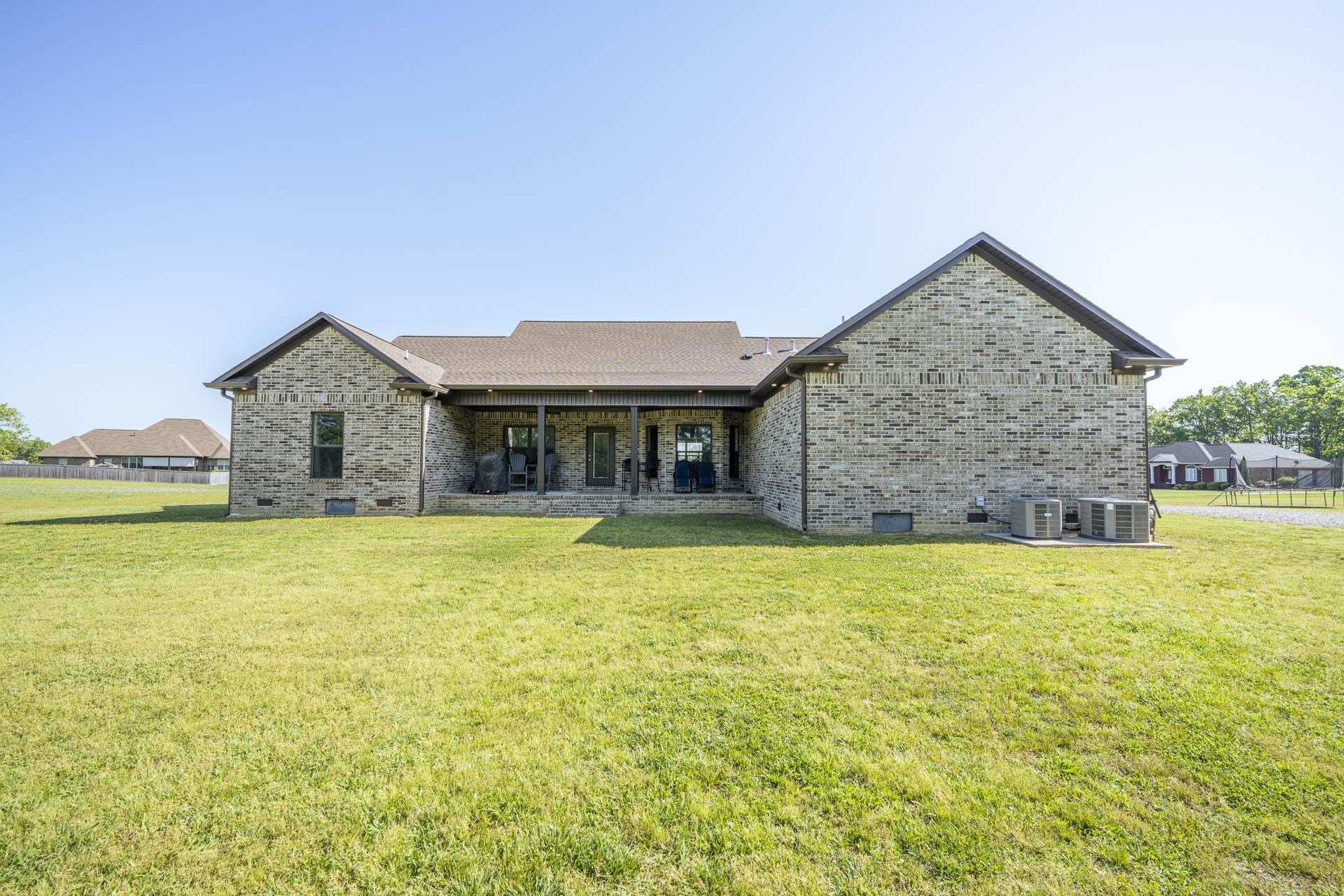 170 Kirk Cove Adamsville, TN 38310 - Photo 35 of 39 Back of property with crawl space, brick siding, a yard, and a patio