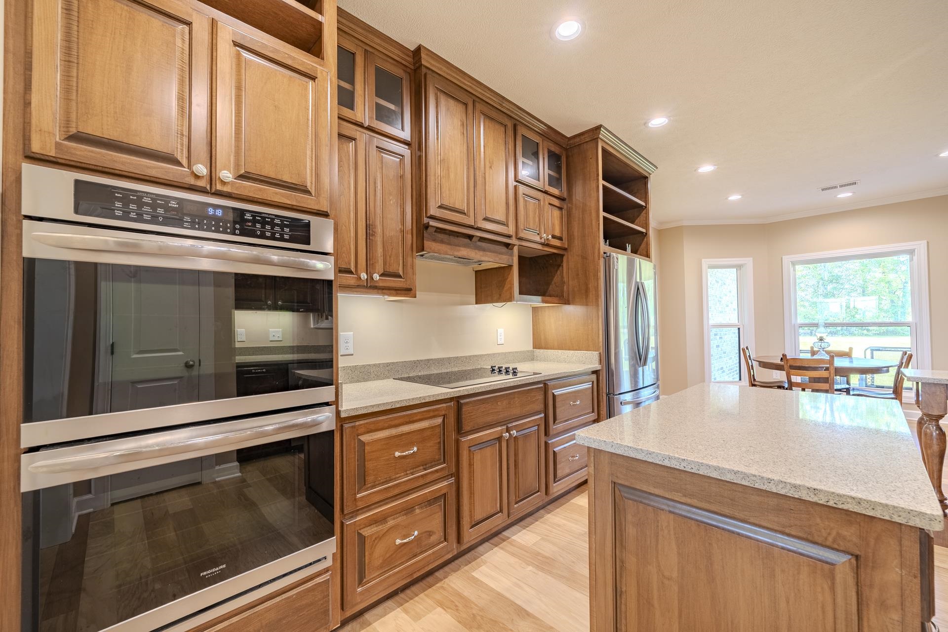 170 Kirk Cove Adamsville, TN 38310 - Photo 5 of 39 Kitchen with open shelves, stainless steel appliances, a kitchen island, glass insert cabinets, and recessed lighting