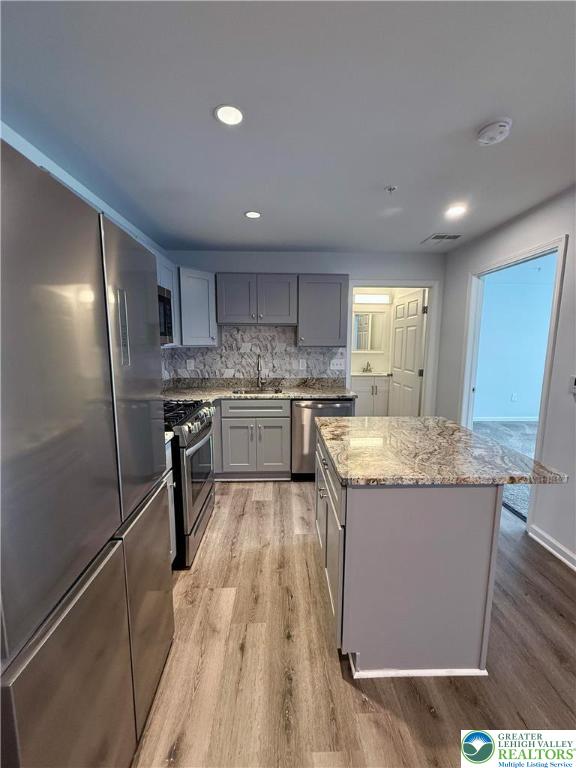 938 East 4th Street, Unit G03 Bethlehem, PA 18015 - Photo 16 of 30 a kitchen with a sink a refrigerator and wooden floor