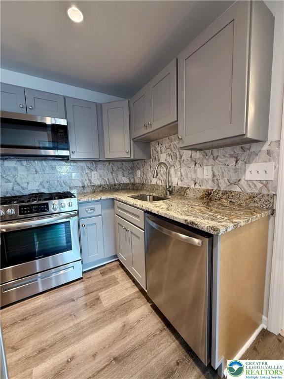 938 East 4th Street, Unit G03 Bethlehem, PA 18015 - Photo 19 of 30 a kitchen with granite countertop a sink and cabinets