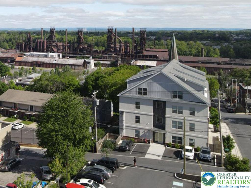 938 East 4th Street, Unit G03 Bethlehem, PA 18015 - Photo 3 of 30 a view of multiple houses with a yard