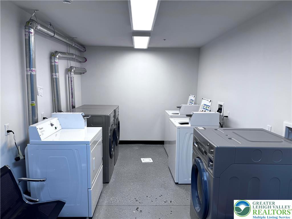 938 East 4th Street, Unit G03 Bethlehem, PA 18015 - Photo 4 of 30 a room with a table chairs and refrigerator