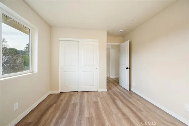 a view of a room with wooden floor and window