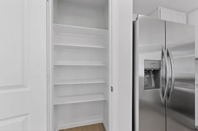 a metallic refrigerator freezer sitting in a kitchen