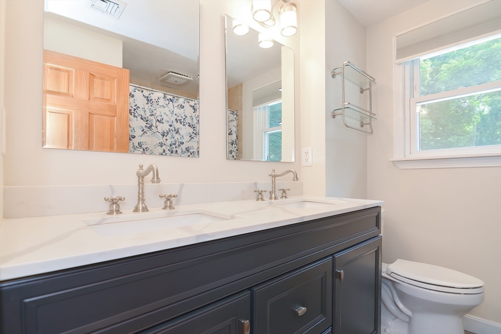 16 August Drive Framingham, MA 01701 - Photo 13 of 27 a bathroom with a sink a toilet and a mirror