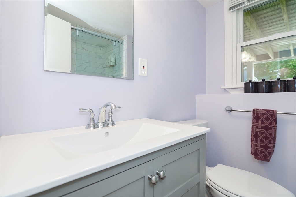 16 August Drive Framingham, MA 01701 - Photo 17 of 27 a bathroom with a sink a toilet and a mirror