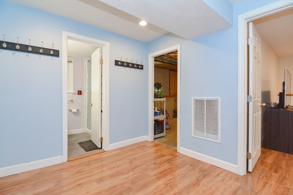 16 August Drive Framingham, MA 01701 - Photo 20 of 27 a view of an empty room with wooden floor and a bathroom