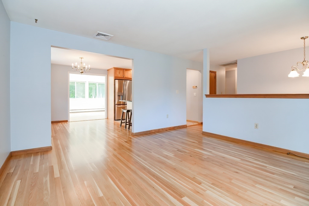 16 August Drive Framingham, MA 01701 - Photo 3 of 27 a view of an empty room with wooden floor and a window