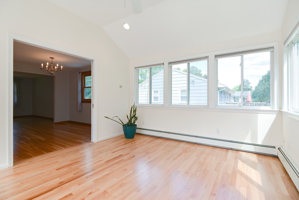 16 August Drive Framingham, MA 01701 - Photo 5 of 27 a view of an empty room with wooden floor and a window
