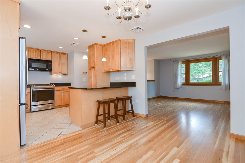 16 August Drive Framingham, MA 01701 - Photo 6 of 27 a view of kitchen with cabinets and wooden floor