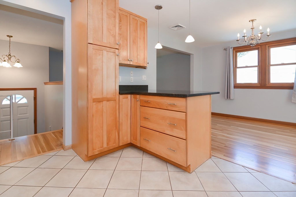 16 August Drive Framingham, MA 01701 - Photo 9 of 27 a kitchen with stainless steel appliances cabinets and wooden floor
