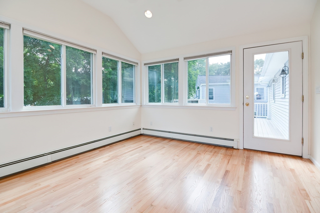 16 August Drive Framingham, MA 01701 - Photo 10 of 27 a view of an empty room with wooden floor and a window