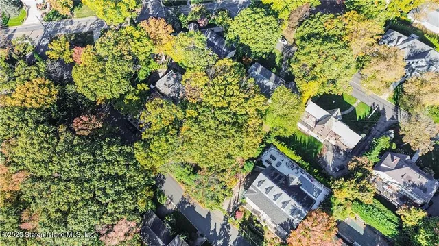 a view of a house with a tree in the background