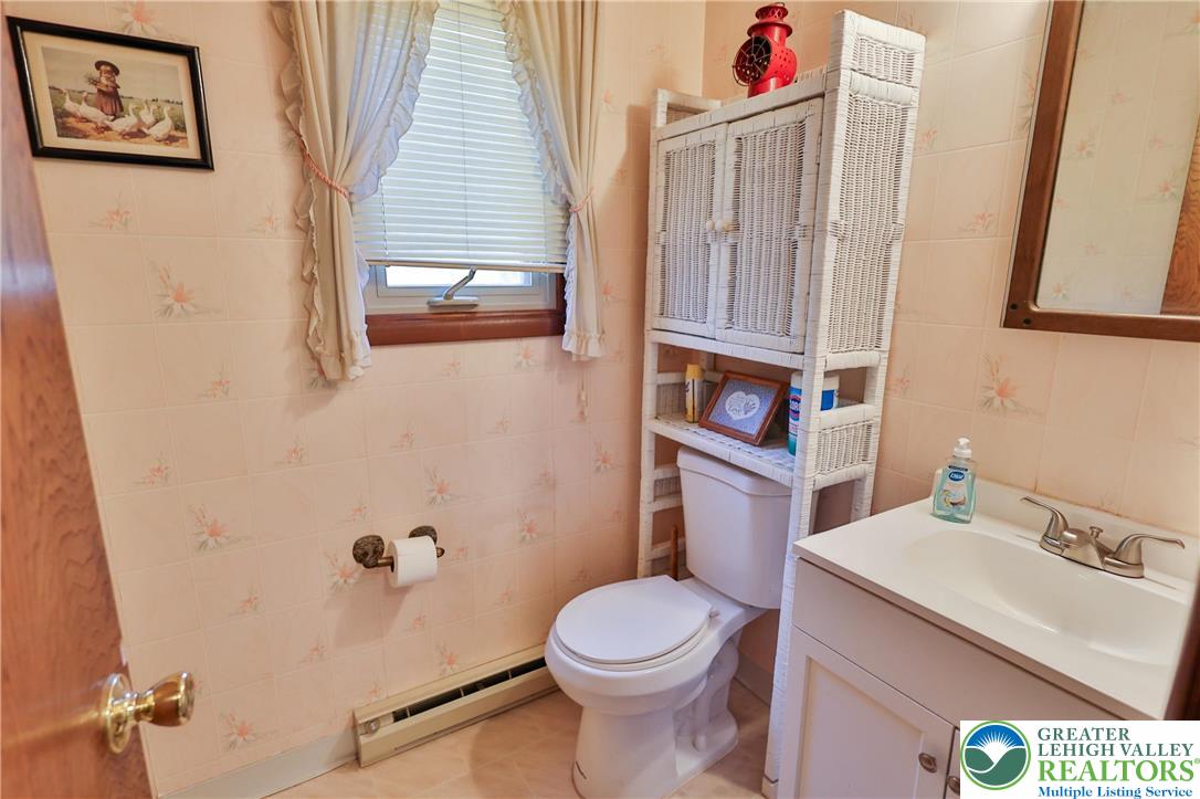 7933 Trails End Fogelsville, PA 18051 - Photo 13 of 32 a bathroom with a sink toilet and window