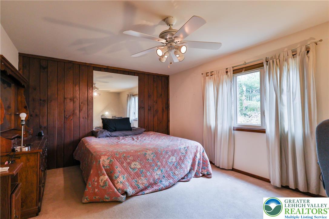 7933 Trails End Fogelsville, PA 18051 - Photo 15 of 32 a bedroom with a bed and a chandelier