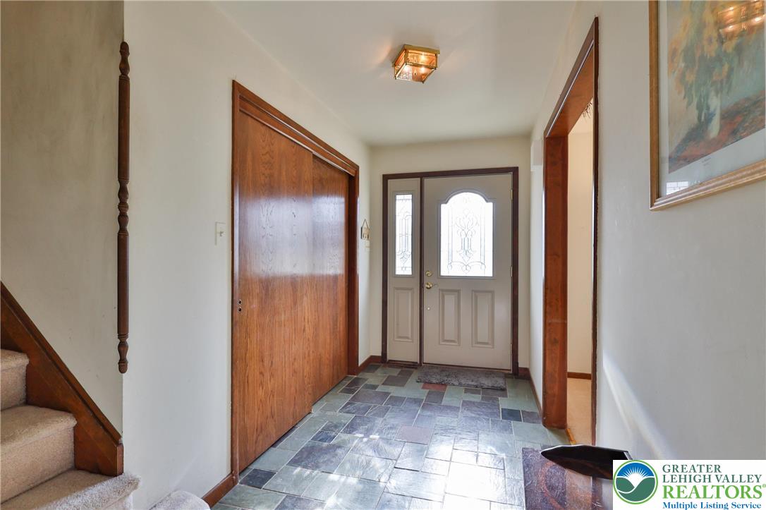 7933 Trails End Fogelsville, PA 18051 - Photo 2 of 32 a view of a hallway with wooden floor and glass door