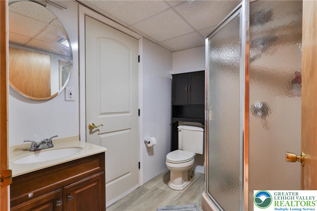 7933 Trails End Fogelsville, PA 18051 - Photo 25 of 32 a bathroom with a granite countertop sink toilet and shower