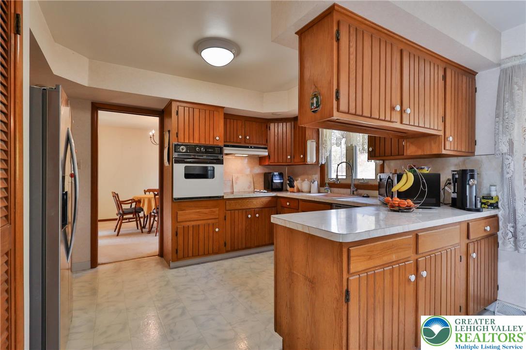 7933 Trails End Fogelsville, PA 18051 - Photo 4 of 32 a kitchen with stainless steel appliances granite countertop a sink stove and refrigerator