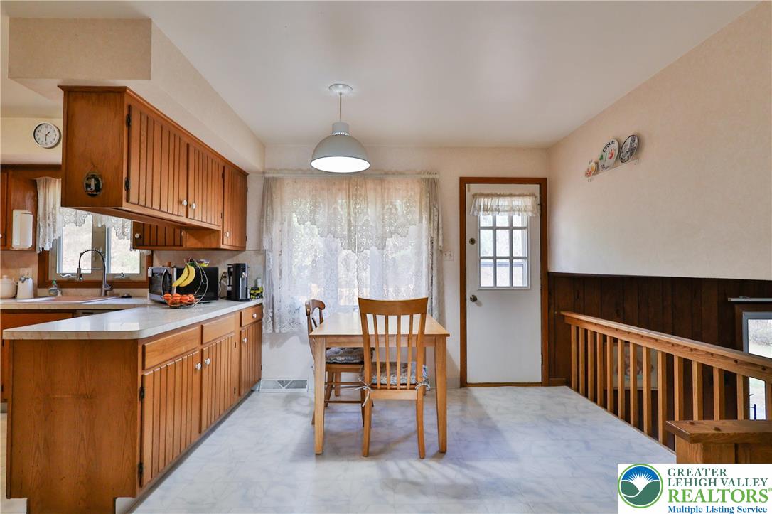 7933 Trails End Fogelsville, PA 18051 - Photo 7 of 32 a kitchen that has a lot of cabinets in it and wooden floors