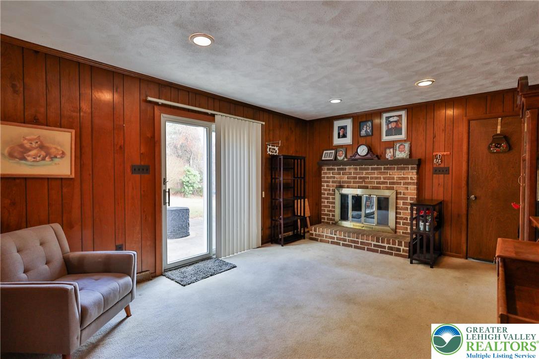 7933 Trails End Fogelsville, PA 18051 - Photo 10 of 32 a living room with furniture and a fireplace