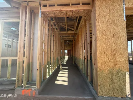 a view of a hallway with wooden floor and entryway