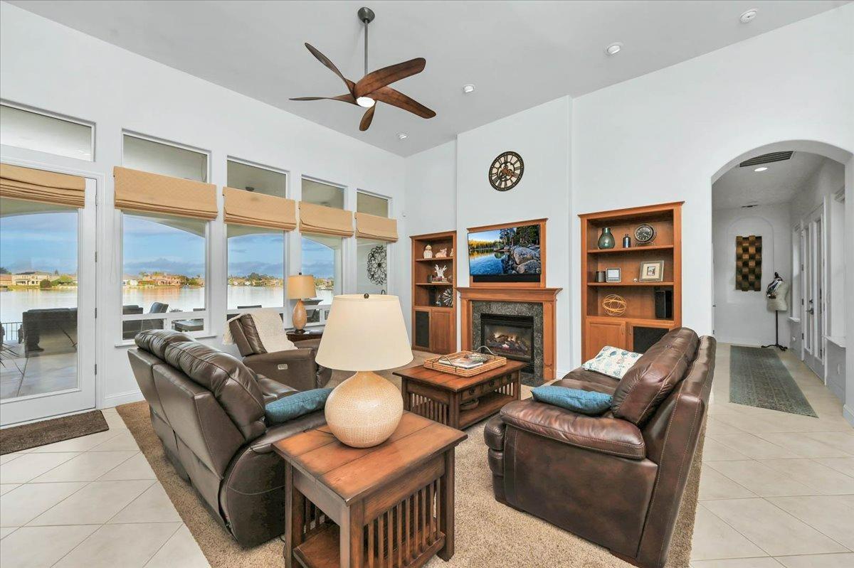 4574 North Quail Lake Drive Clovis, CA 93619 - Photo 13 of 77 a living room with furniture a fireplace and a large window