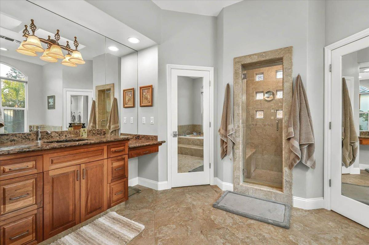 4574 North Quail Lake Drive Clovis, CA 93619 - Photo 30 of 77 a spacious bathroom with a granite countertop sink mirror and shower