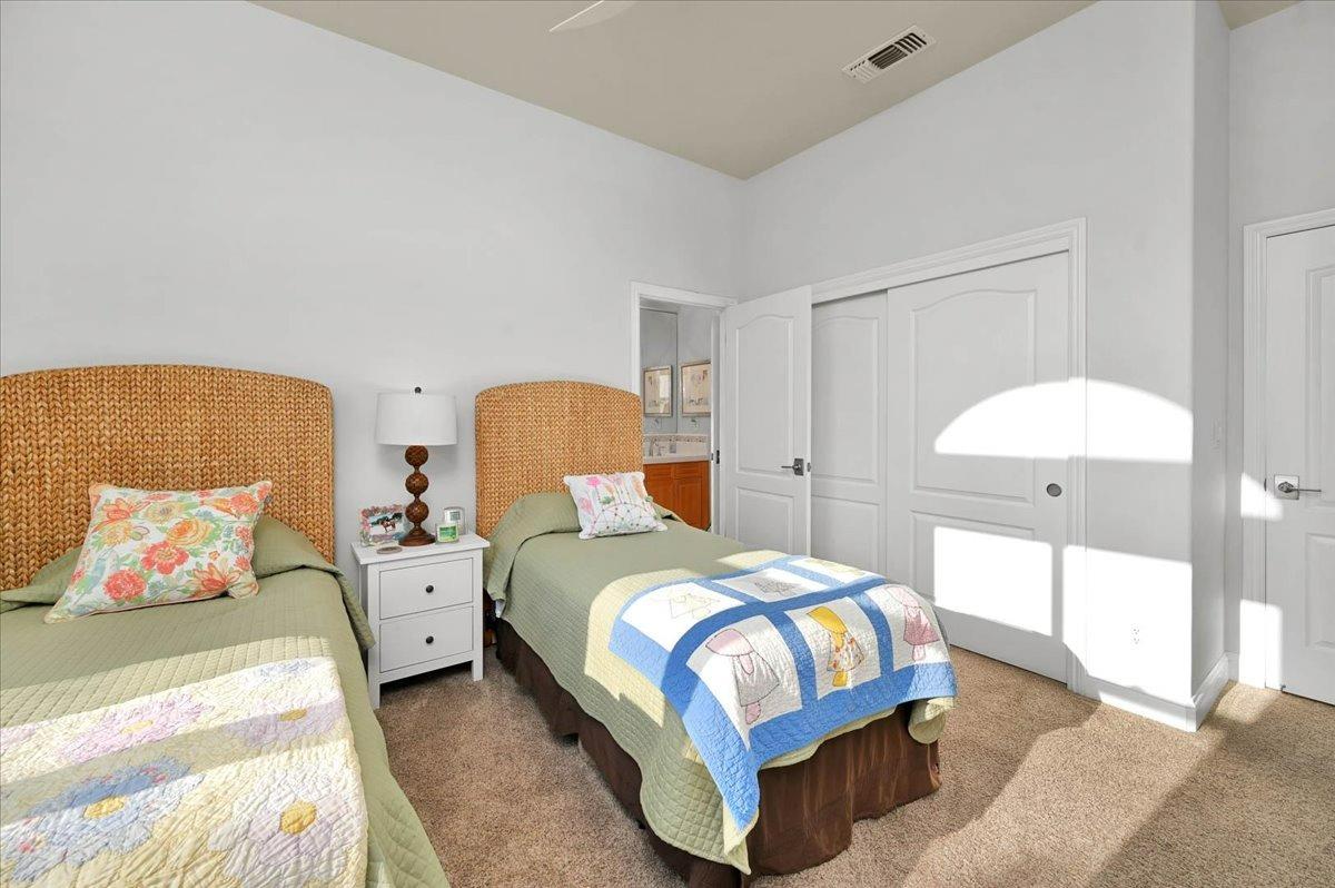 4574 North Quail Lake Drive Clovis, CA 93619 - Photo 36 of 77 a bedroom with two beds and a painting on the wall