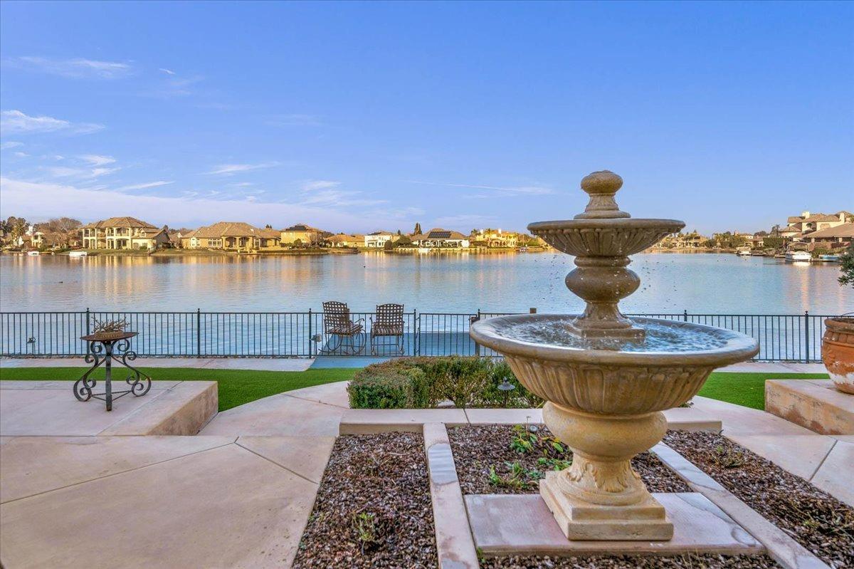 4574 North Quail Lake Drive Clovis, CA 93619 - Photo 50 of 77 a view of a lake with a table and chairs next to a yard