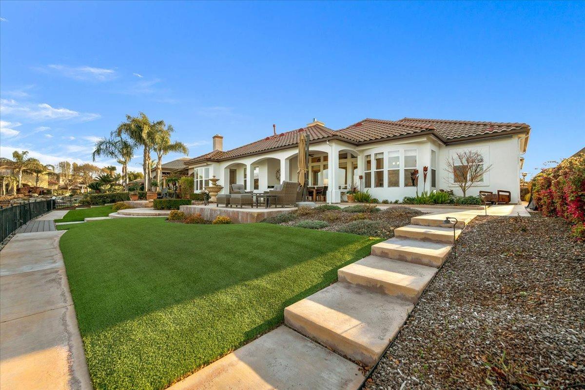 4574 North Quail Lake Drive Clovis, CA 93619 - Photo 56 of 77 a front view of a house with a yard table and chairs