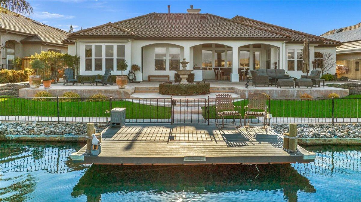 4574 North Quail Lake Drive Clovis, CA 93619 - Photo 64 of 77 a front view of a house with a yard table and chairs