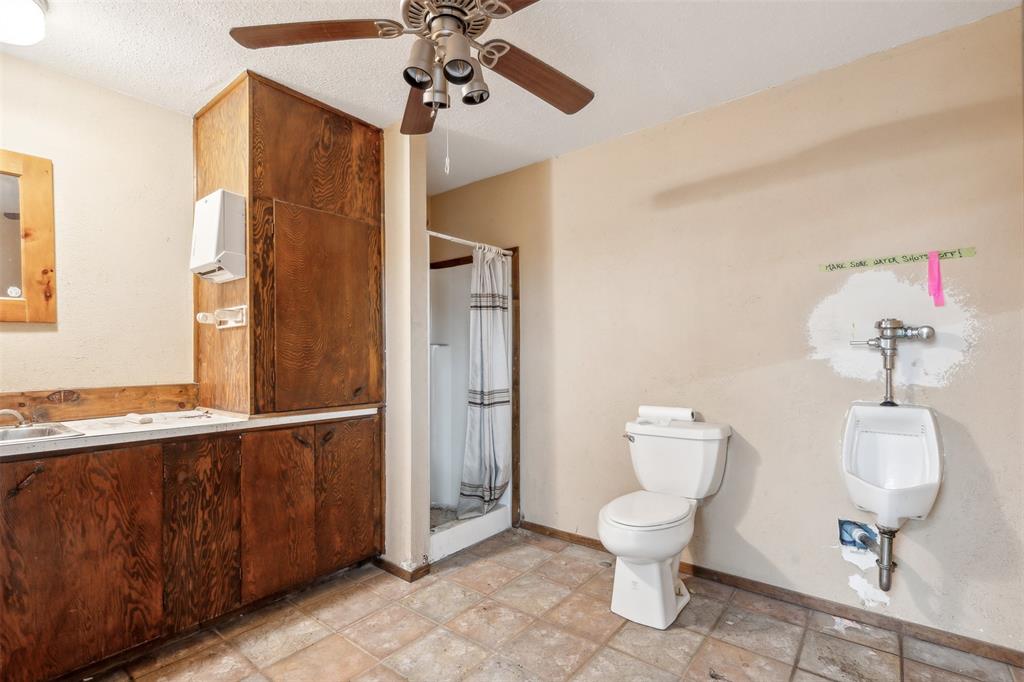 8740 Interstate 20 Eastland, TX 76448 - Photo 19 of 35 a bathroom with a toilet a sink and mirror