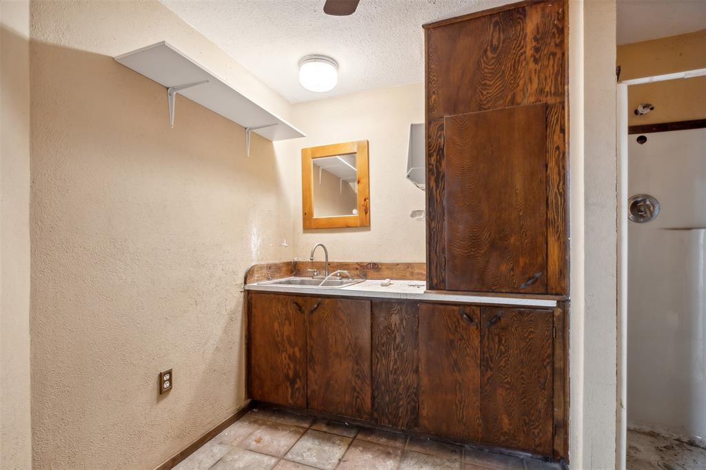 8740 Interstate 20 Eastland, TX 76448 - Photo 20 of 35 Bathroom featuring a textured ceiling, large vanity, and tile flooring