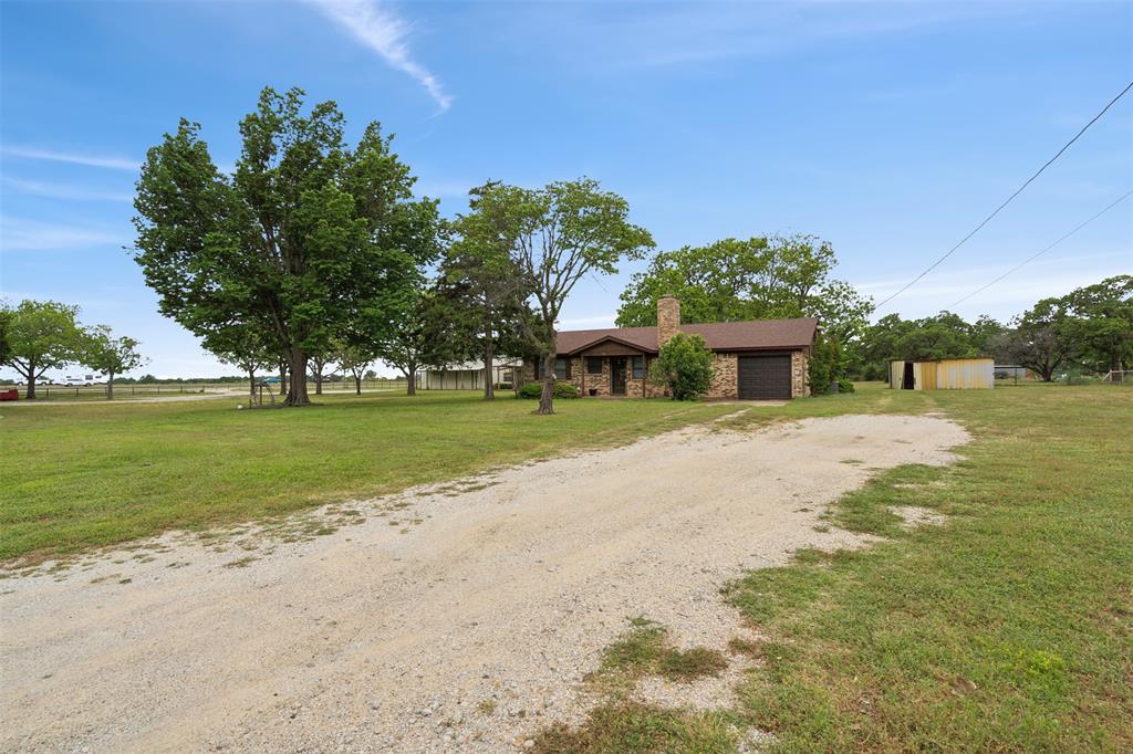 8740 Interstate 20 Eastland, TX 76448 - Photo 33 of 35 Ranch-style house featuring a front yard and a storage shed