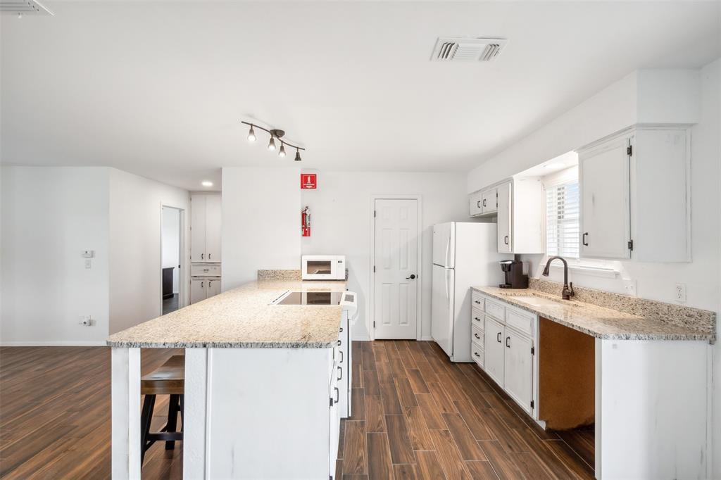 8740 Interstate 20 Eastland, TX 76448 - Photo 8 of 35 a kitchen with granite countertop a sink stove and cabinets