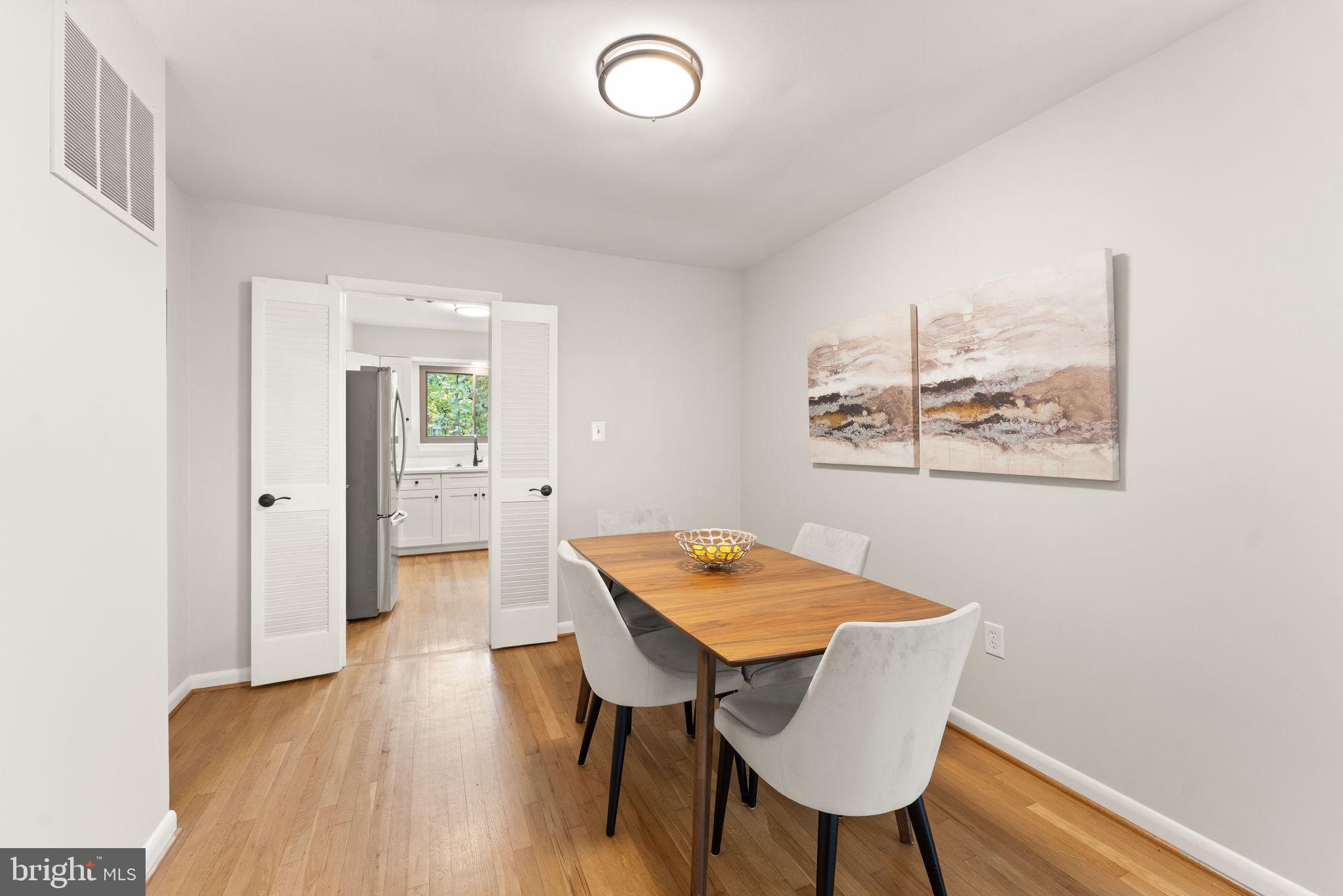 11917 Escalante Court Reston, VA 20191 - Photo 12 of 51 a view of a dining room with furniture and wooden floor