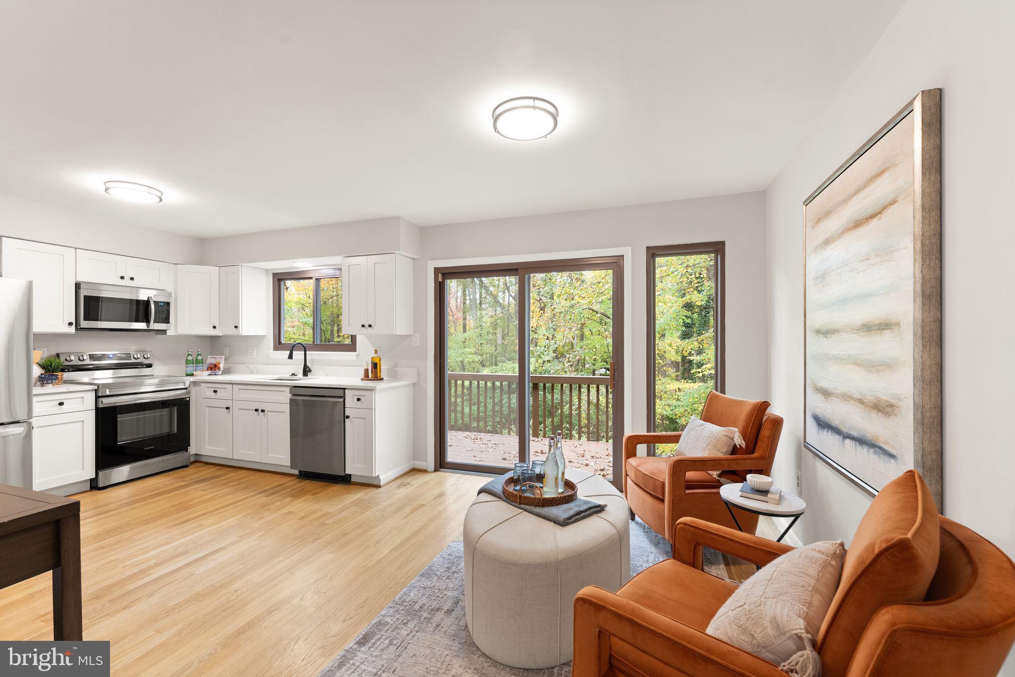 11917 Escalante Court Reston, VA 20191 - Photo 15 of 51 a large white kitchen with a large window and a counter space